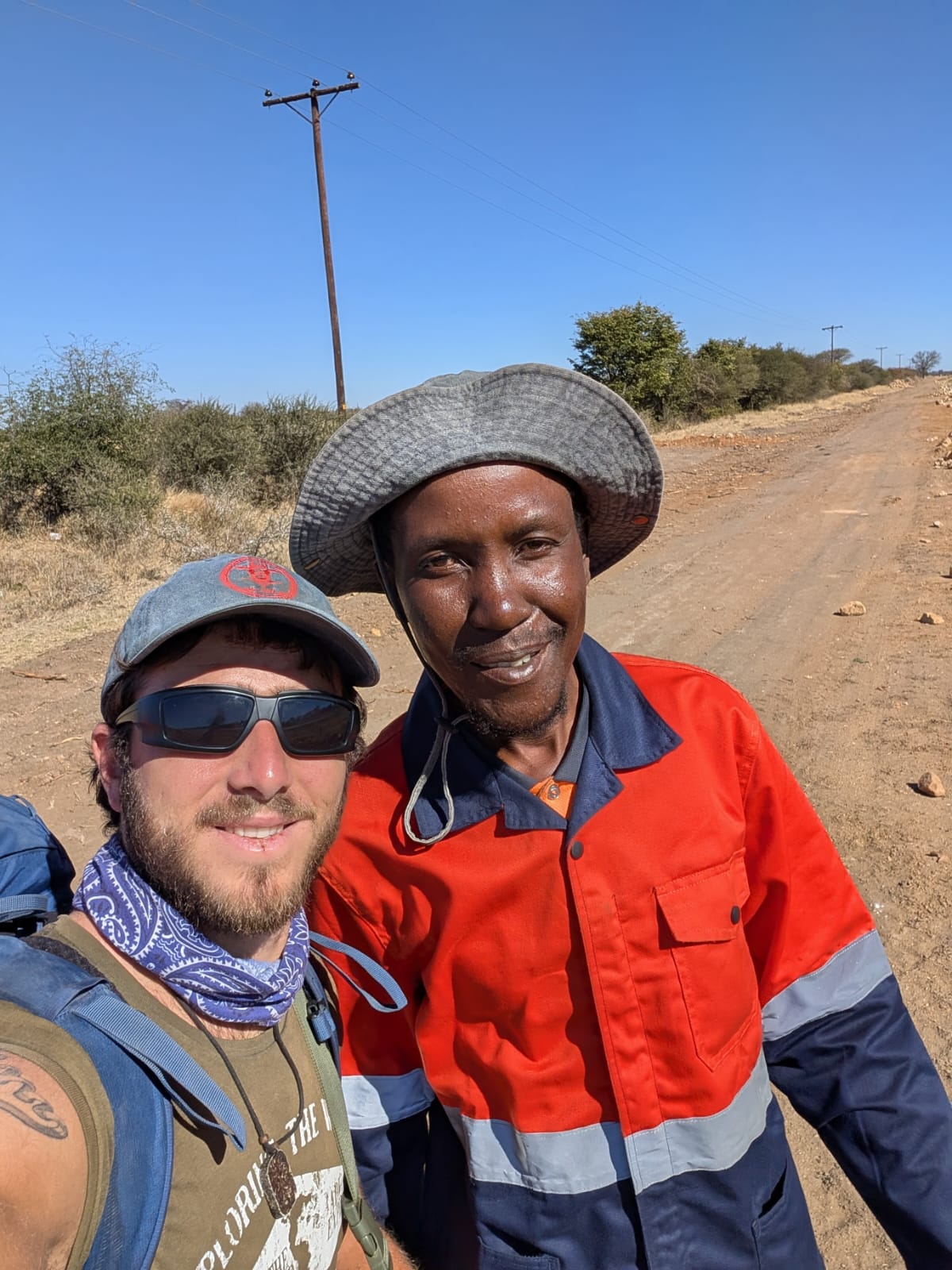 Two people photographed together on a rural Botswana road